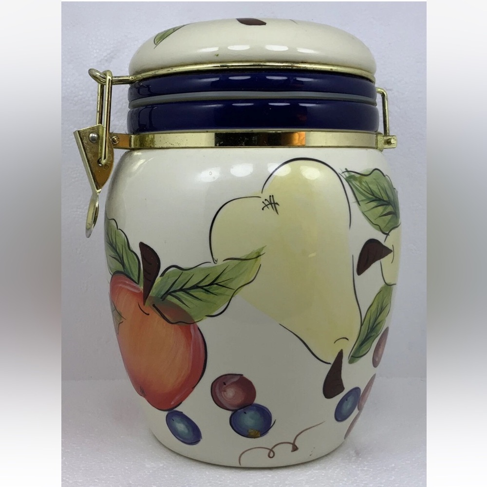 Vintage Knots Berry Farm ceramic canister with air tight metal lock lid. 9”